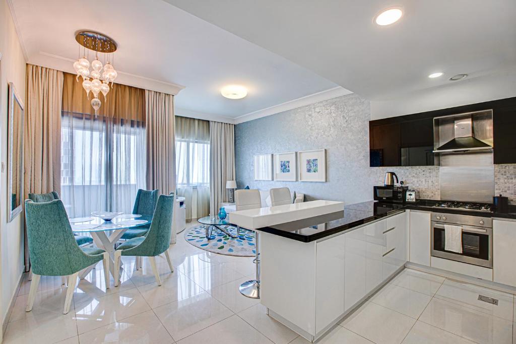 a kitchen and dining room with a table and chairs at Remarkable apartment in Downtown near Dubai Mall in Dubai