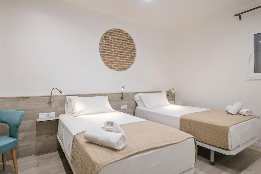 A bed or beds in a room at Stay Together Barcelona Apartments