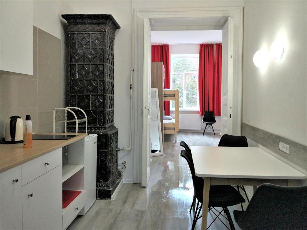 a kitchen and dining room with a table and red curtains at Modern apartment in Lviv