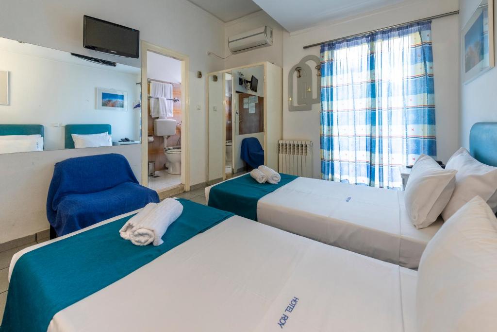 Postel nebo postele na pokoji v ubytování ROY Hotel