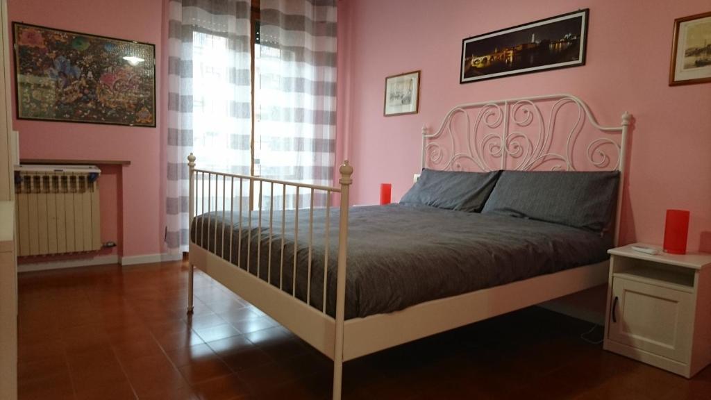 um quarto com uma cama num quarto com paredes cor-de-rosa em LaMoka Verona em Verona
