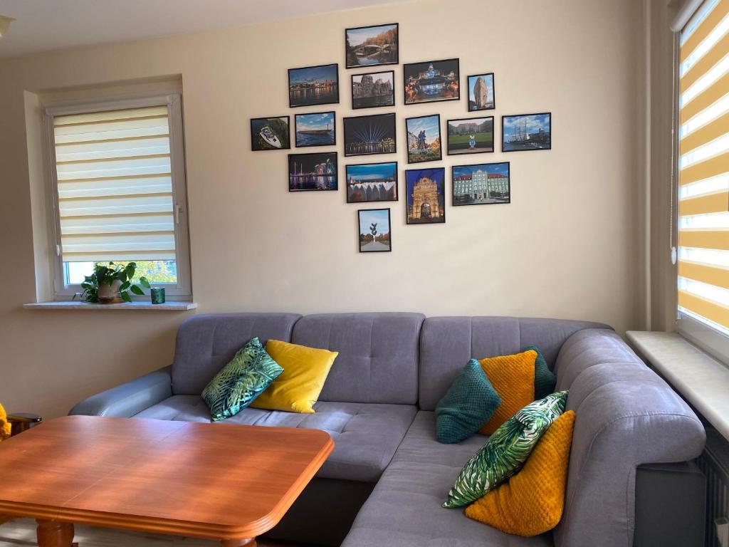 a living room with a couch and a table at Apartament Arkońska in Szczecin