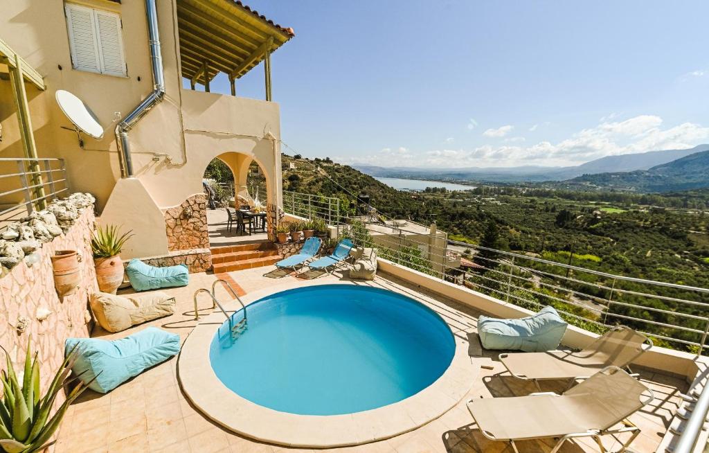 a house with a swimming pool on a balcony at Aloe Villa Chania Crete in Georgioupolis