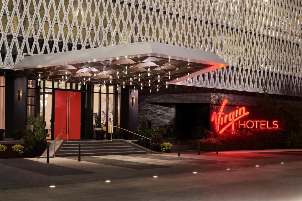 a hotel with a neon sign in front of a building at Virgin Hotels Dallas in Dallas