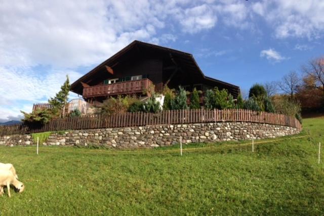 a house on top of a stone wall in a field at Schoenblick in Chiusa