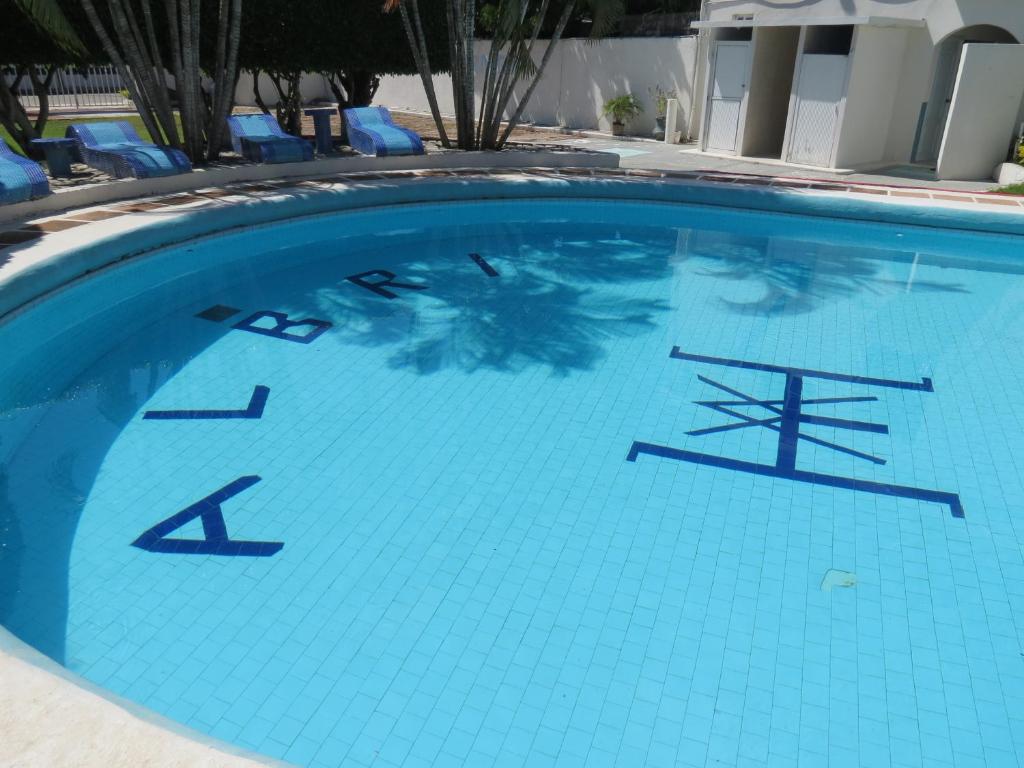 a large swimming pool with blue tiles on it at Hotel Albri by Rotamundos in Tecolutla