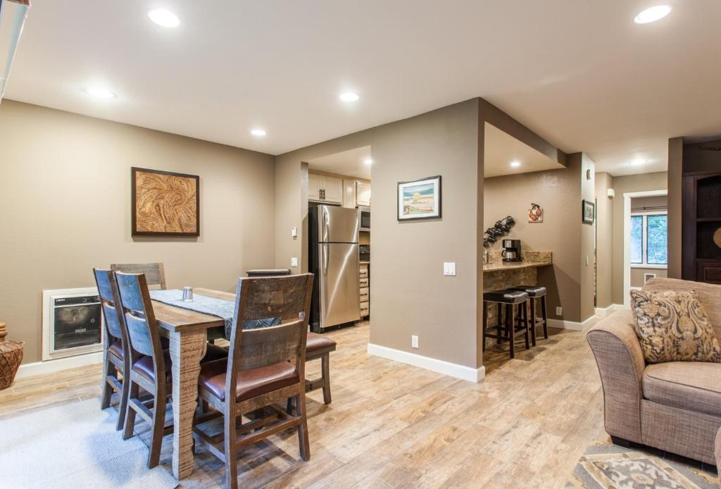 a dining room and living room with a table and chairs at Snowcreek #405 - Phase III in Mammoth Lakes