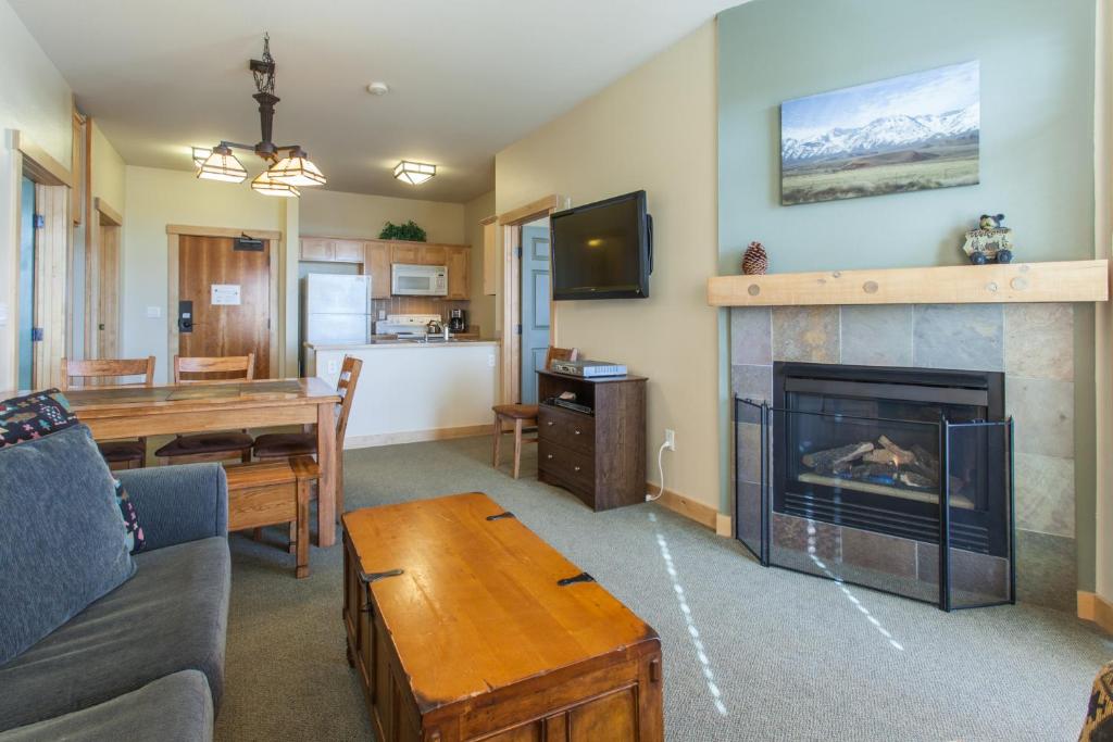 a living room with a couch and a fireplace at Sunstone # 329 in Mammoth Lakes