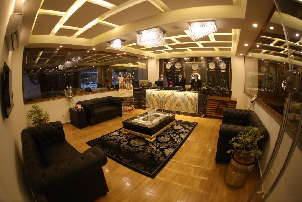 an overhead view of a living room with chairs and a table at Grand Mongolia Hotel in Rawalpindi