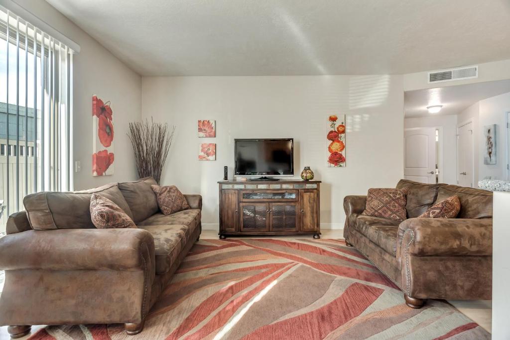 a living room with two couches and a flat screen tv at Downtown Condo Near Convention Center (Disability Access) in Salt Lake City