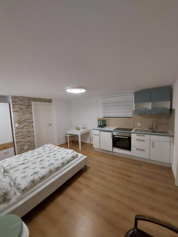 a large kitchen with a bed in a room at Lavendel Apartment in Riederich