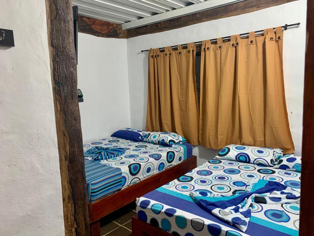 two bunk beds in a room with a curtain at Cabaña hotel conde in Doradal