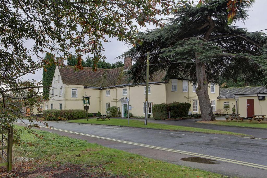 a street in front of a large yellow building at The Cedars Hotel in Stowmarket