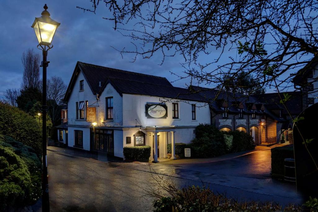 a white house with a street light in front of it at The Tollgate Bed & Breakfast in Steyning