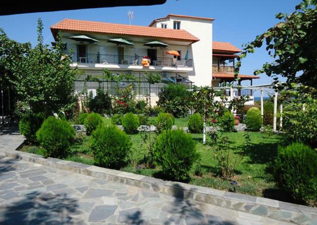 a house with a garden in front of it at Harilaos Beach in Plaka Litochorou