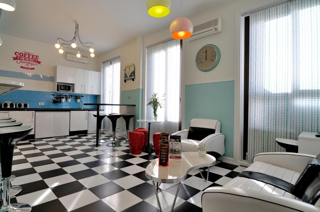 a kitchen and living room with a checkered floor at Far Home Plaza Mayor in Madrid
