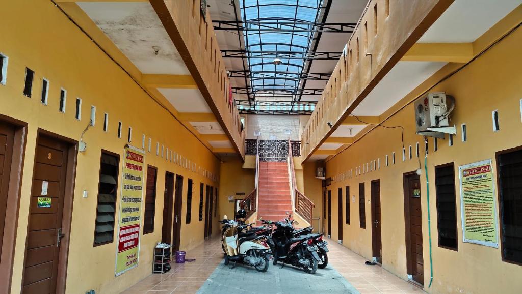 two motorcycles parked in a hallway of a building at Yellow House in Sunggal