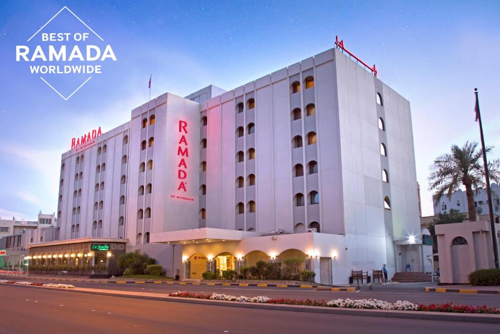 a large white building with a redania hotel at Ramada by Wyndham Bahrain in Manama