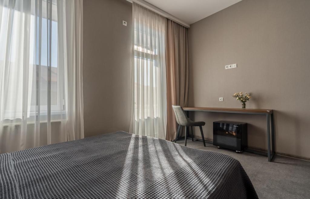 Postel nebo postele na pokoji v ubytování Hotel History • სასტუმრო ისტორია