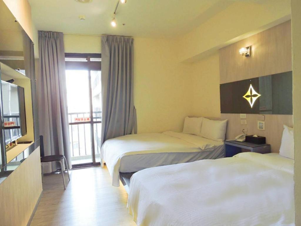 Postel nebo postele na pokoji v ubytování Walker Hotel - Chenggong