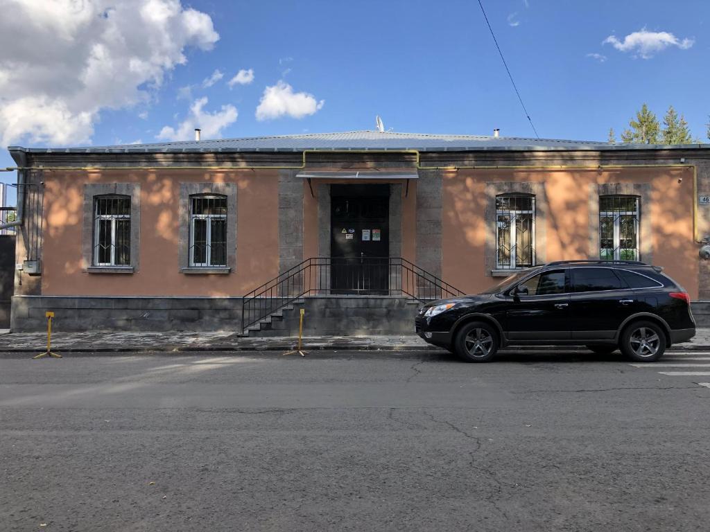 a black car parked in front of a building at Ideal in Akhalk'alak'i