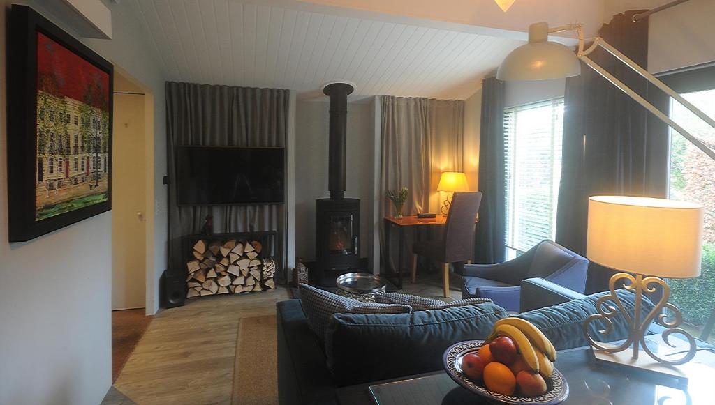 a living room with a living room with a wood stove at The Cabin in Cheltenham