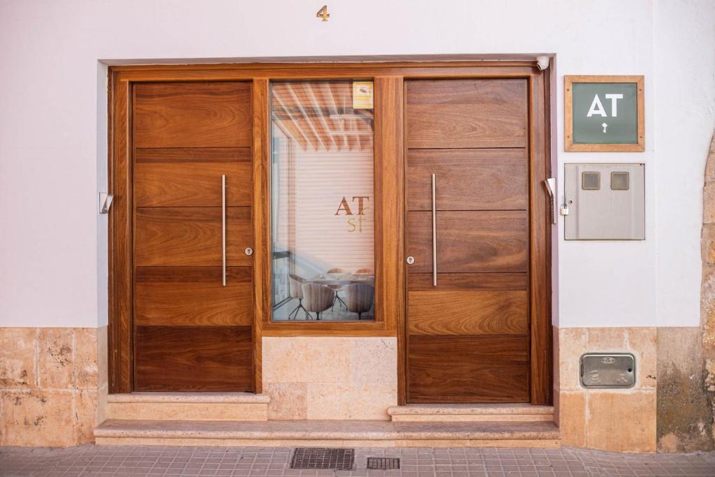 an entrance to a building with two wooden doors at Apartamentos San Francisco - Centrico in Mota del Cuervo