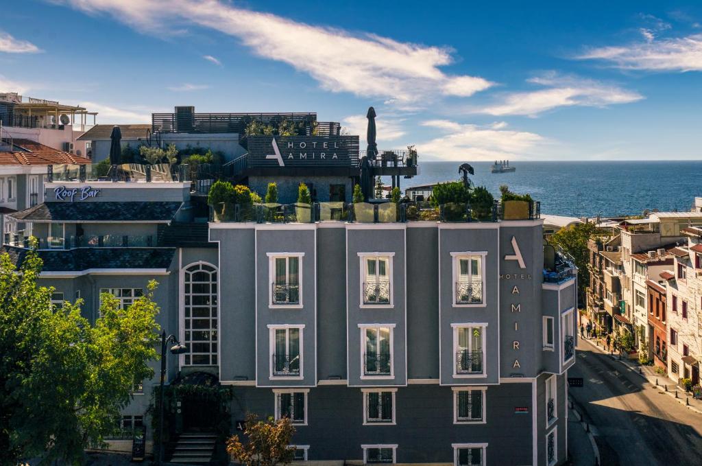 an apartment building in front of the ocean at Hotel Amira Istanbul in Istanbul