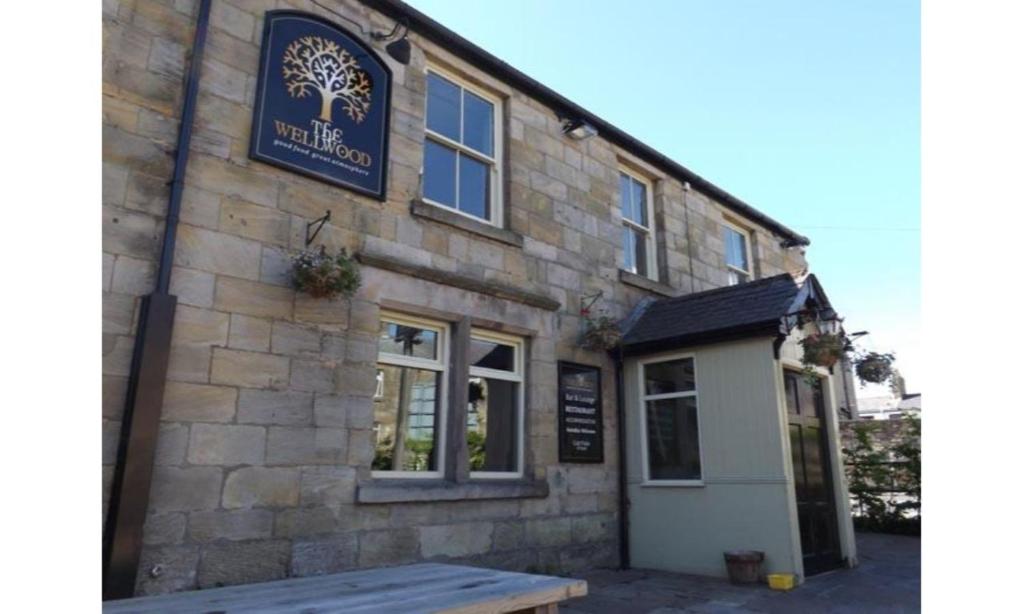 a building with a sign on the side of it at The Wellwood in Amble