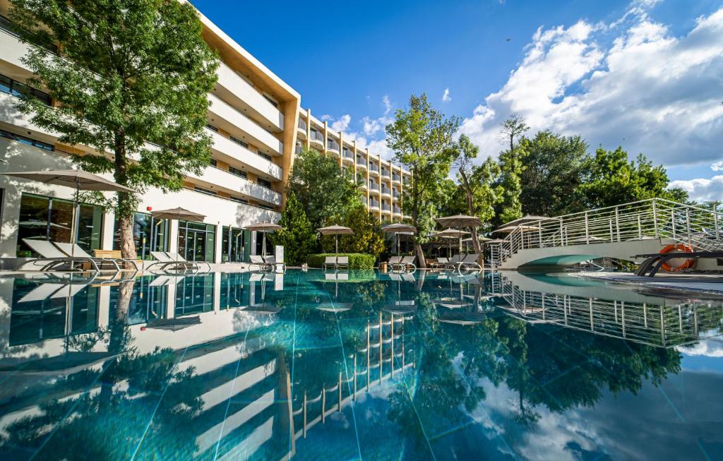 a swimming pool in front of a hotel at HVD Club Bor Ultra All Inclusive - Private Beach & Free parking in Sunny Beach