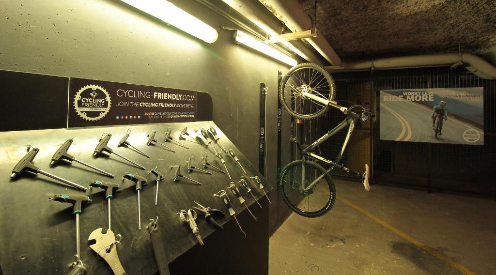 a bike is hanging on a wall in a garage at Hôtel de Brienne in Toulouse