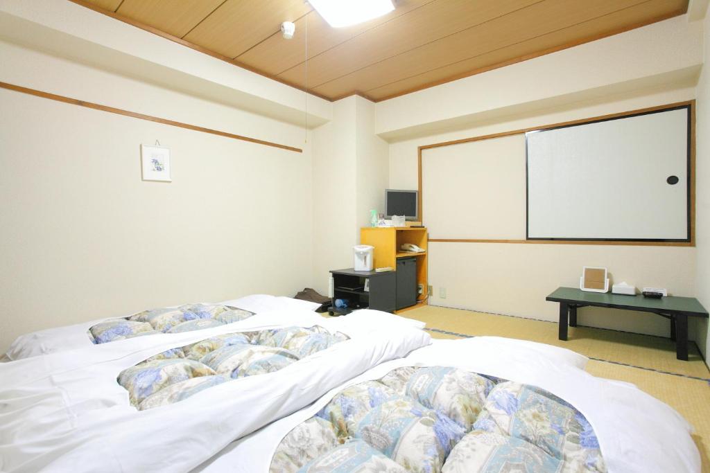 Postel nebo postele na pokoji v ubytování Hotel Marutani