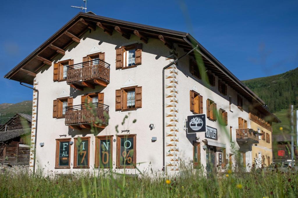 a building with wooden windows and balconies on it at Castellani Livigno Apartments in Livigno