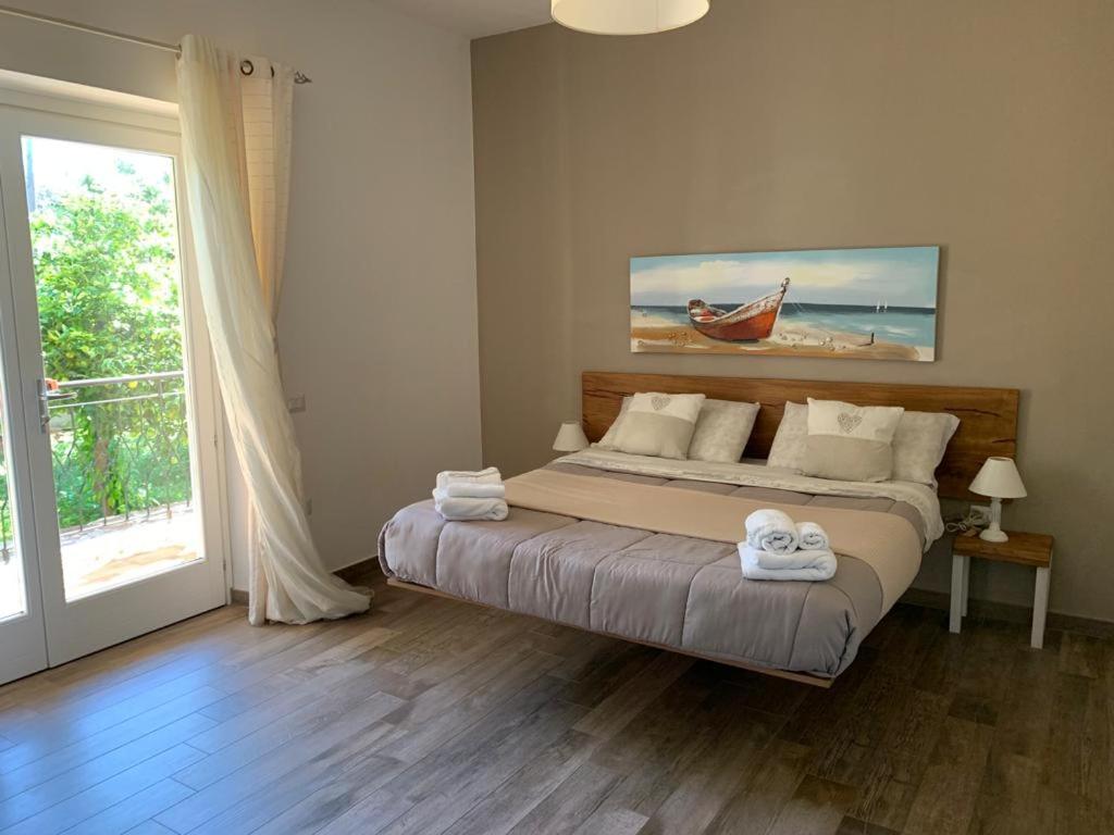 a bedroom with a bed with towels on it at Etesia in Olbia