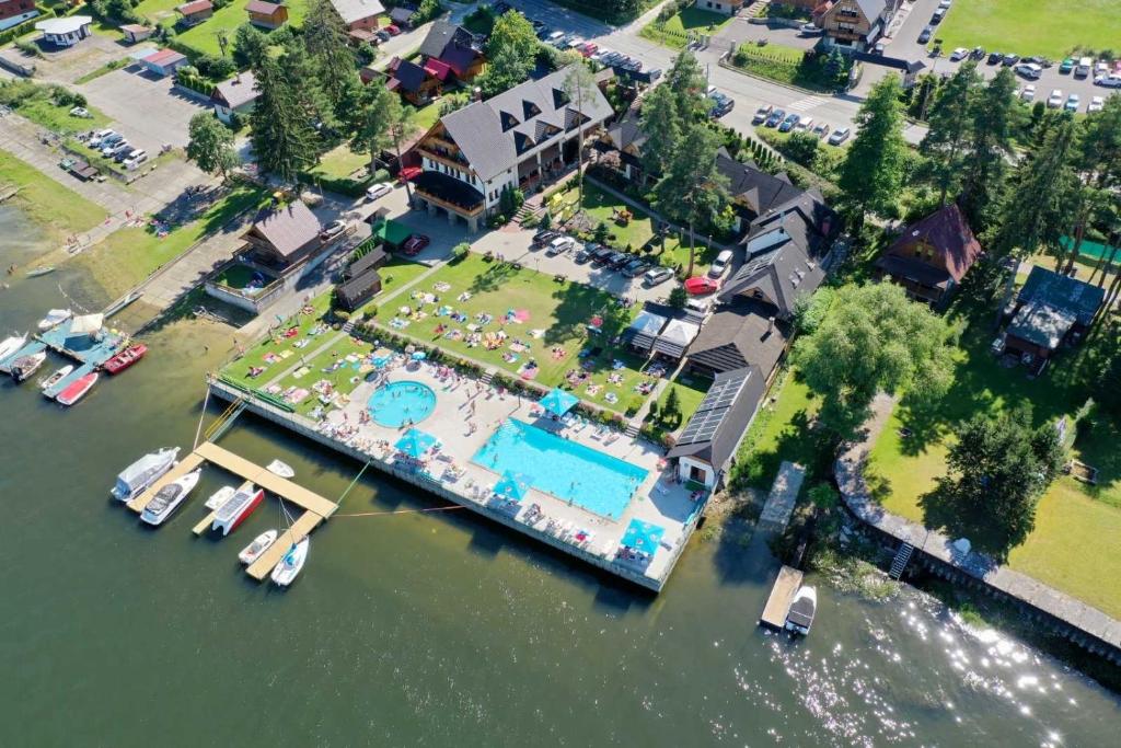 an aerial view of a house with boats in the water at Slanický Dvor in Námestovo