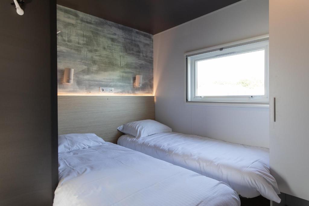 Postel nebo postele na pokoji v ubytování Holidaypark Klein Strand