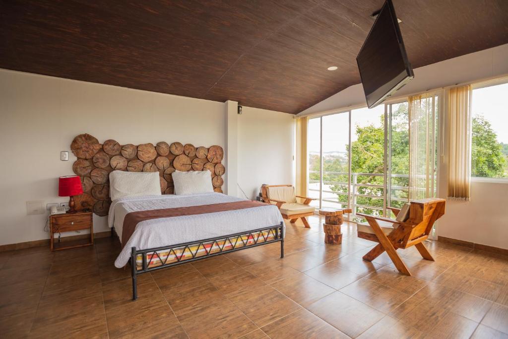 En eller flere senge i et værelse på Hotel Campestre La Posada Del Rancho