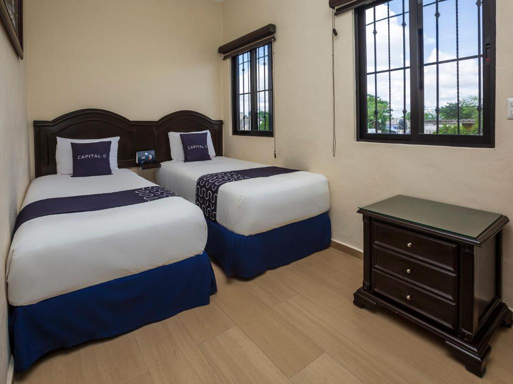 Postel nebo postele na pokoji v ubytování Woo Rooms Hotel