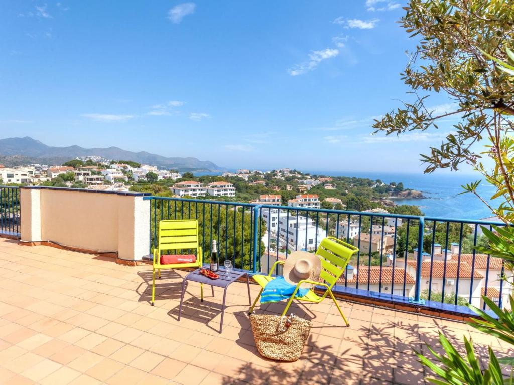 a patio with two chairs and a table on a balcony at Apartment L'Olivar II by Interhome in Llança