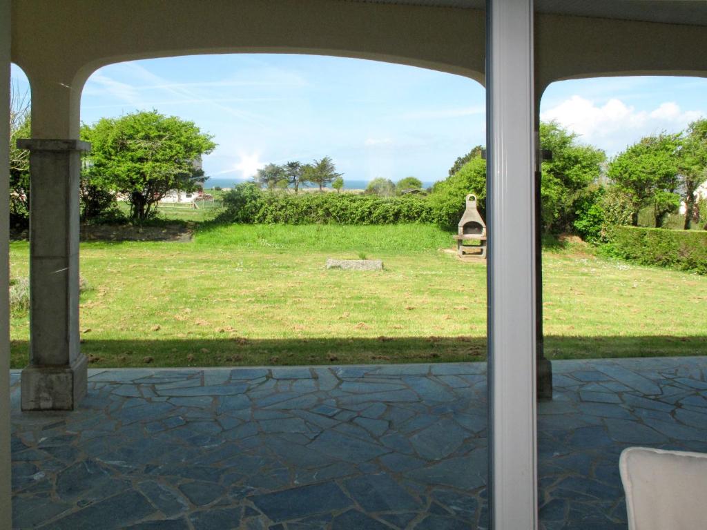 a view of a yard from a patio door at Holiday Home La Jolie Vague by Interhome in Beaubigny