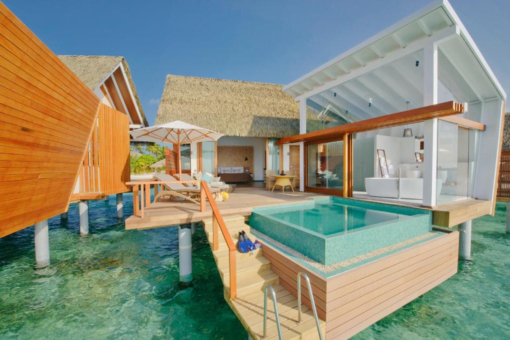 a house on the water with a swimming pool at Kandolhu Maldives in Himandhoo 