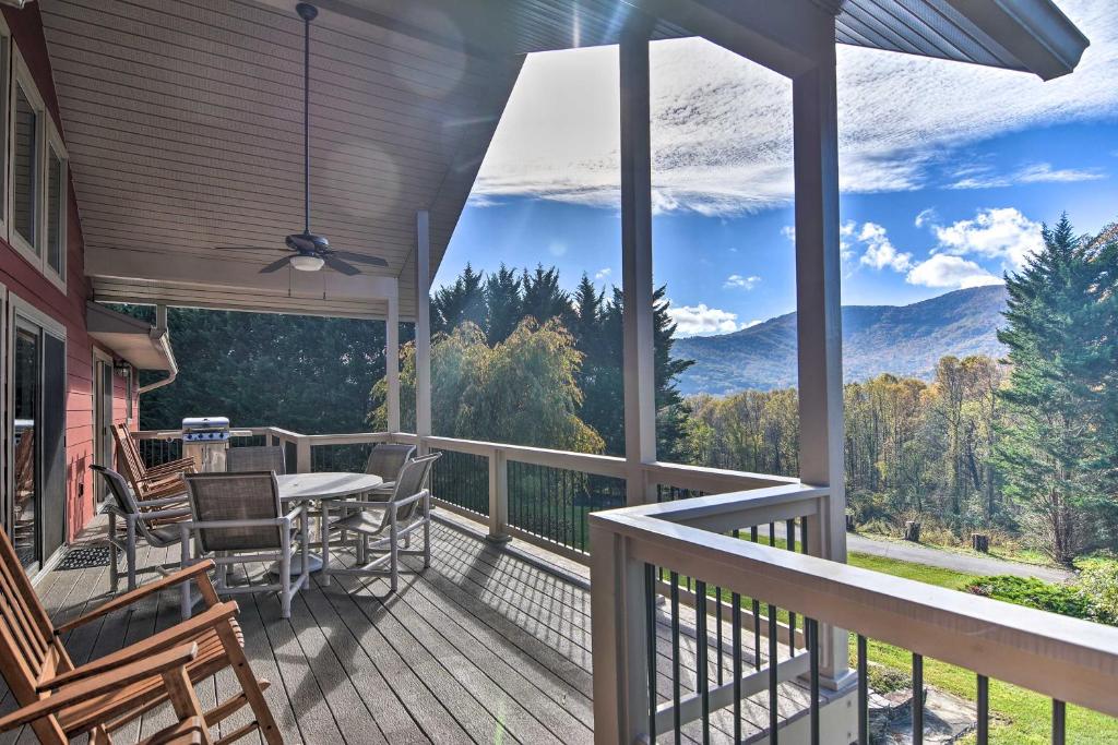 a balcony with a table and chairs and a view of the mountains at Tranquil 6-Acre Escape with Hot Tub and Mtn Views! in Swannanoa