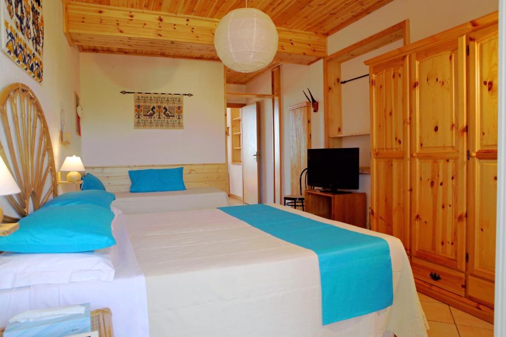 Postel nebo postele na pokoji v ubytování Domus De Janas Sul Mare