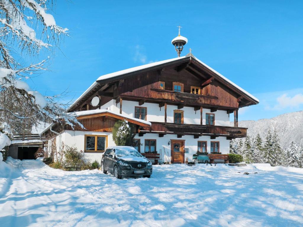 a house with a car parked in the snow at Holiday Home Schwalbenhof by Interhome in Oberau