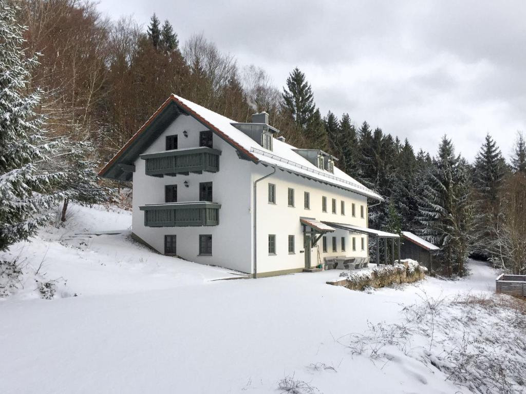 a white house in the snow with trees at Holiday Home Kreuzbuche by Interhome in Viechtach
