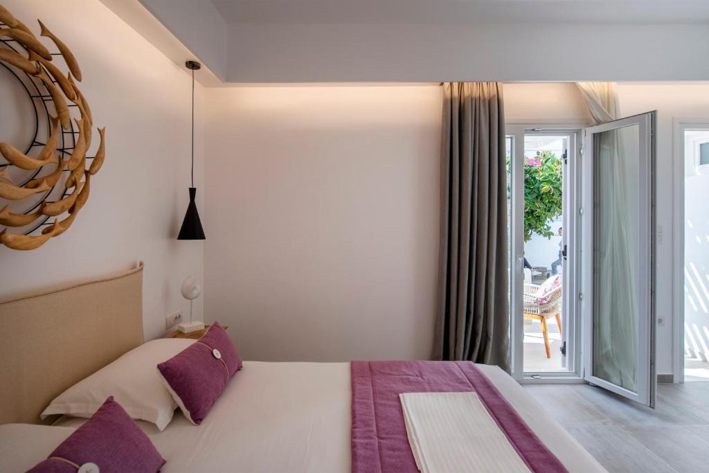 Łóżko lub łóżka w pokoju w obiekcie Corina Studios-Apartments