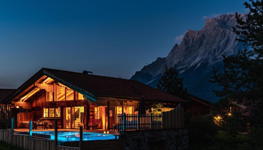 a house with a pool in front of a mountain at LaPosch - Dein Bergaway in Biberwier