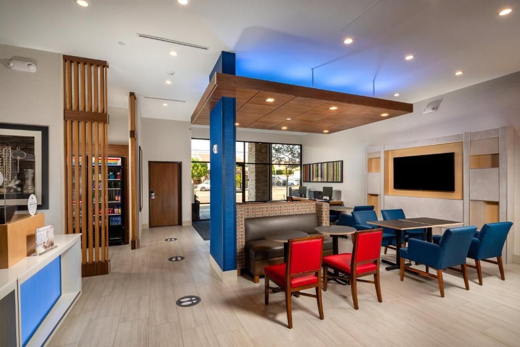 a dining room with red chairs and a table at Holiday Inn Express & Suites Chatsworth, an IHG Hotel in Chatsworth