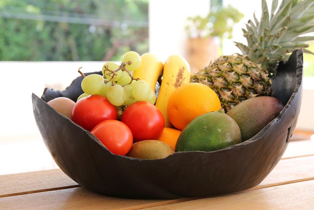 a wooden bowl filled with fruit on a table at Casa Bodhi Boutique Hotel & Spa in Marbella