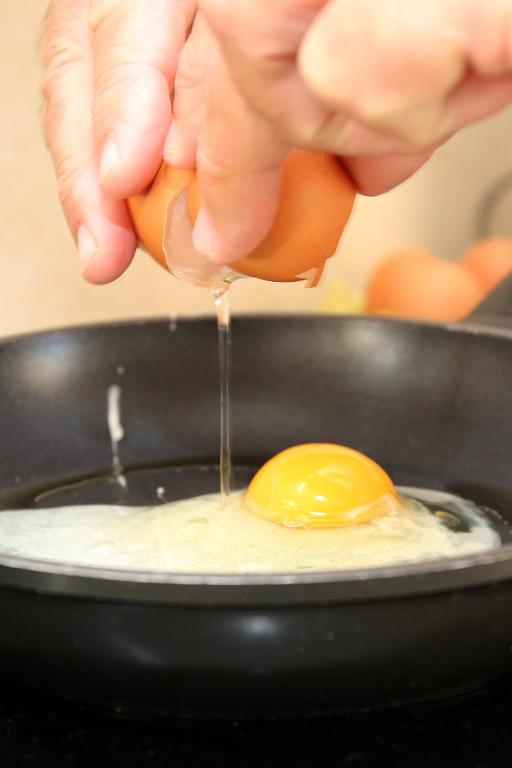 a person is holding an egg in a pan at Casa Bodhi Boutique Hotel & Spa in Marbella